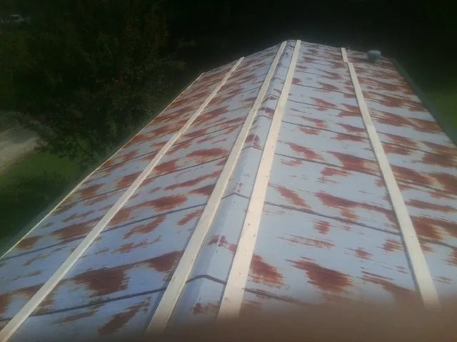 Rusted metal roof panels with new wood purlins before replacement — Storm Damage Roof Repair in Prompton by Roofing Brothers